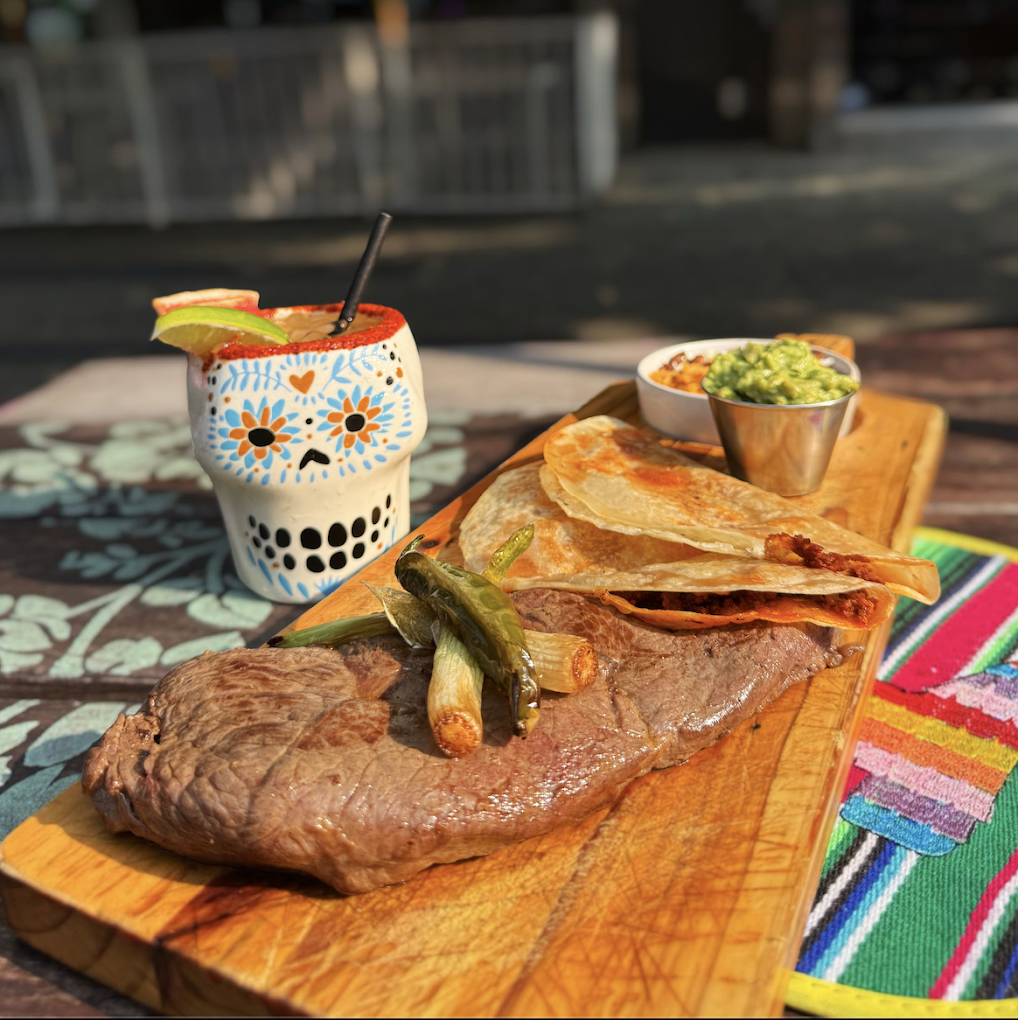 Grilled carne asada steak with a hand-painted sugar skull cup
