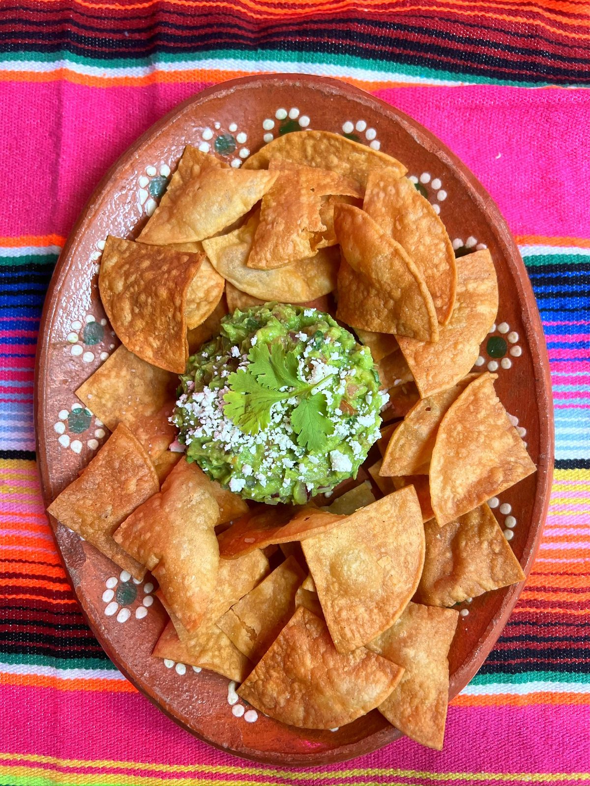 Fresh guacamole with homemade corn chips