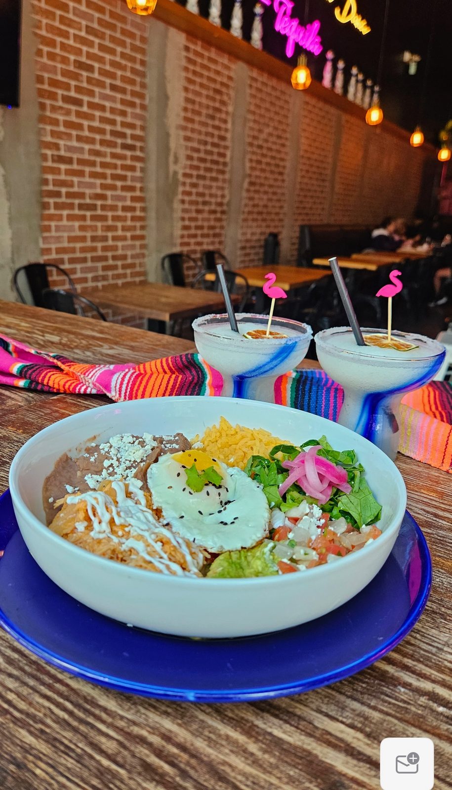 Mexican Bowl with meat, fried egg, rice, beans, guacamole, pico and feta
