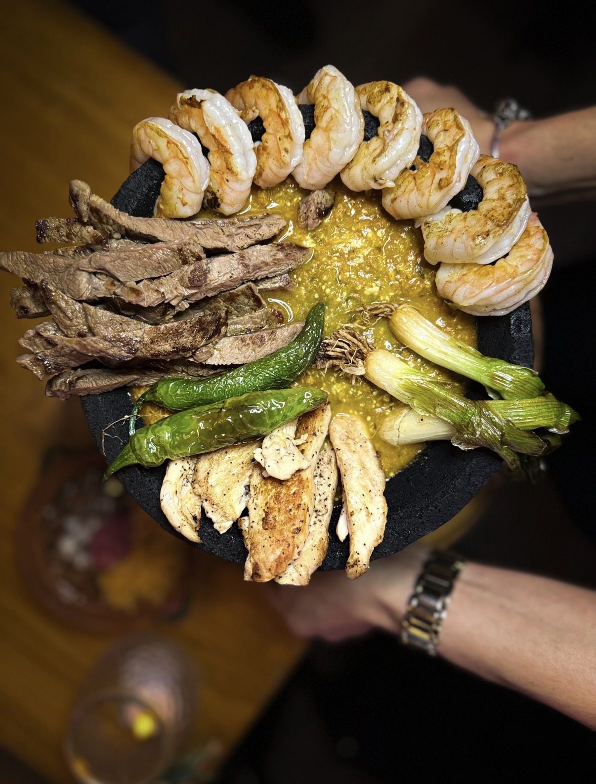 Molcajete Mexicano in volcanic stone bowl with grilled meats
