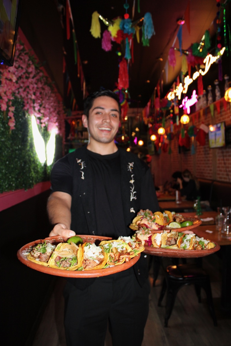 Sopesitos flight of four sampler bites on a wooden platter