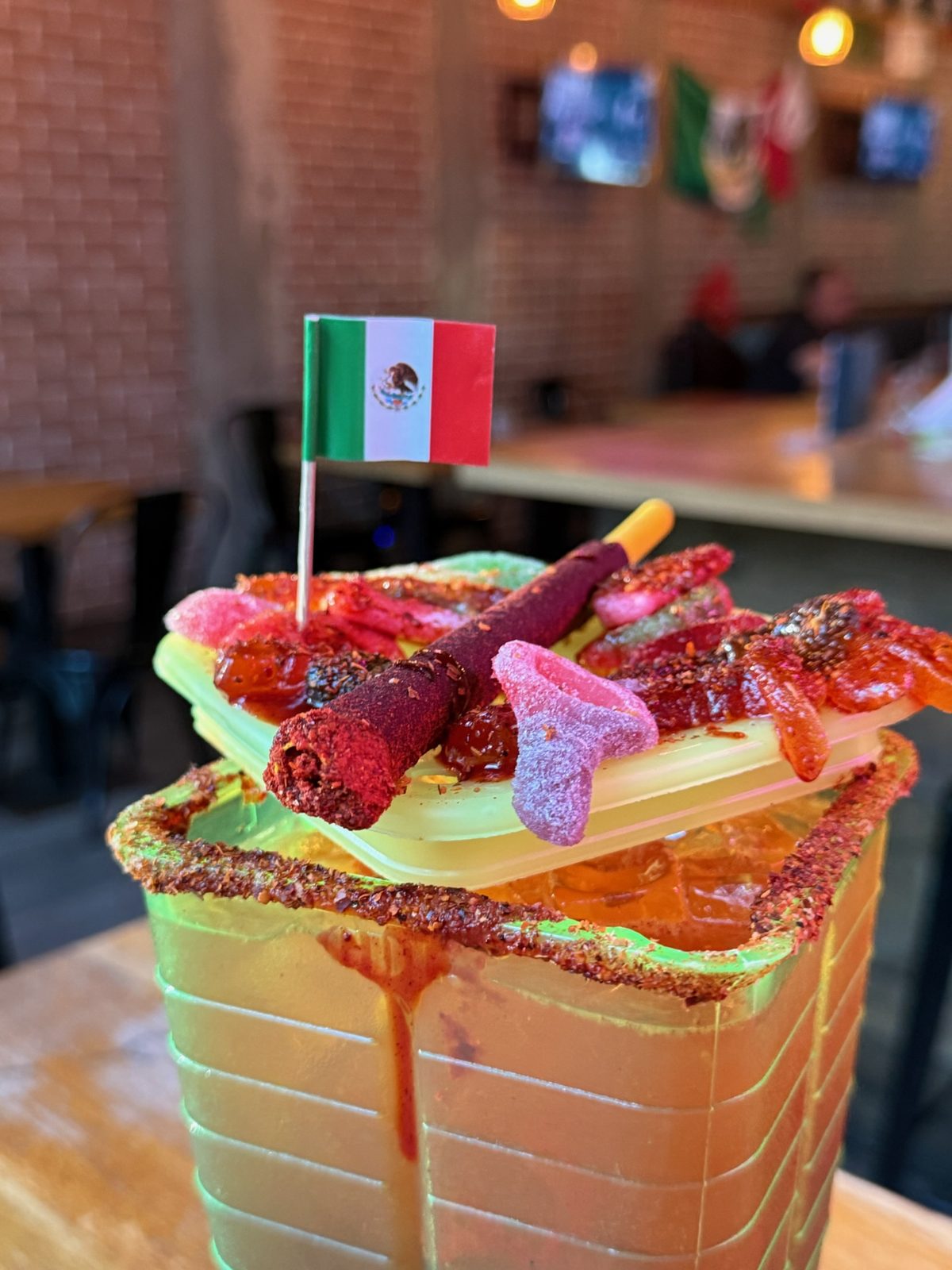 Licuachela with spicy gummies and signature black sauce