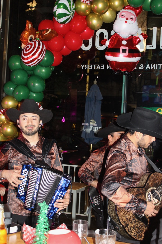 Norteño musicians with accordion and guitar playing live at the cantina